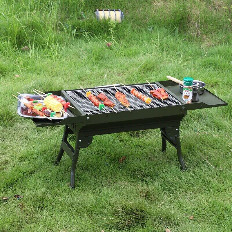 Portable grill in use, end tables on grill. Meat skewers cooking 